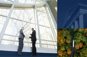 Two insurance specialist talk in front of a massive window